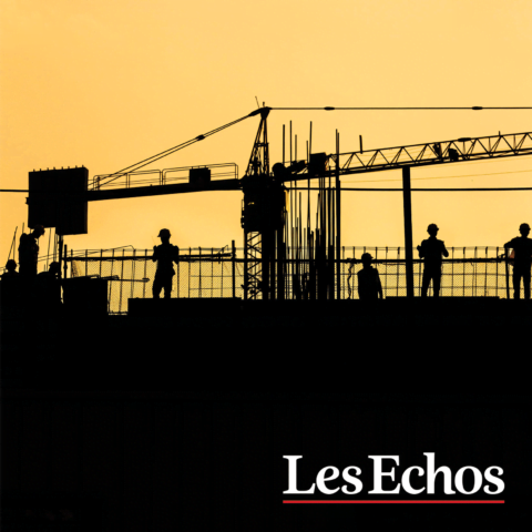 Silhouette of construction workers and a crane